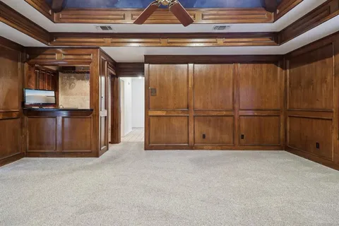 a spacious bedroom with a bed and a window