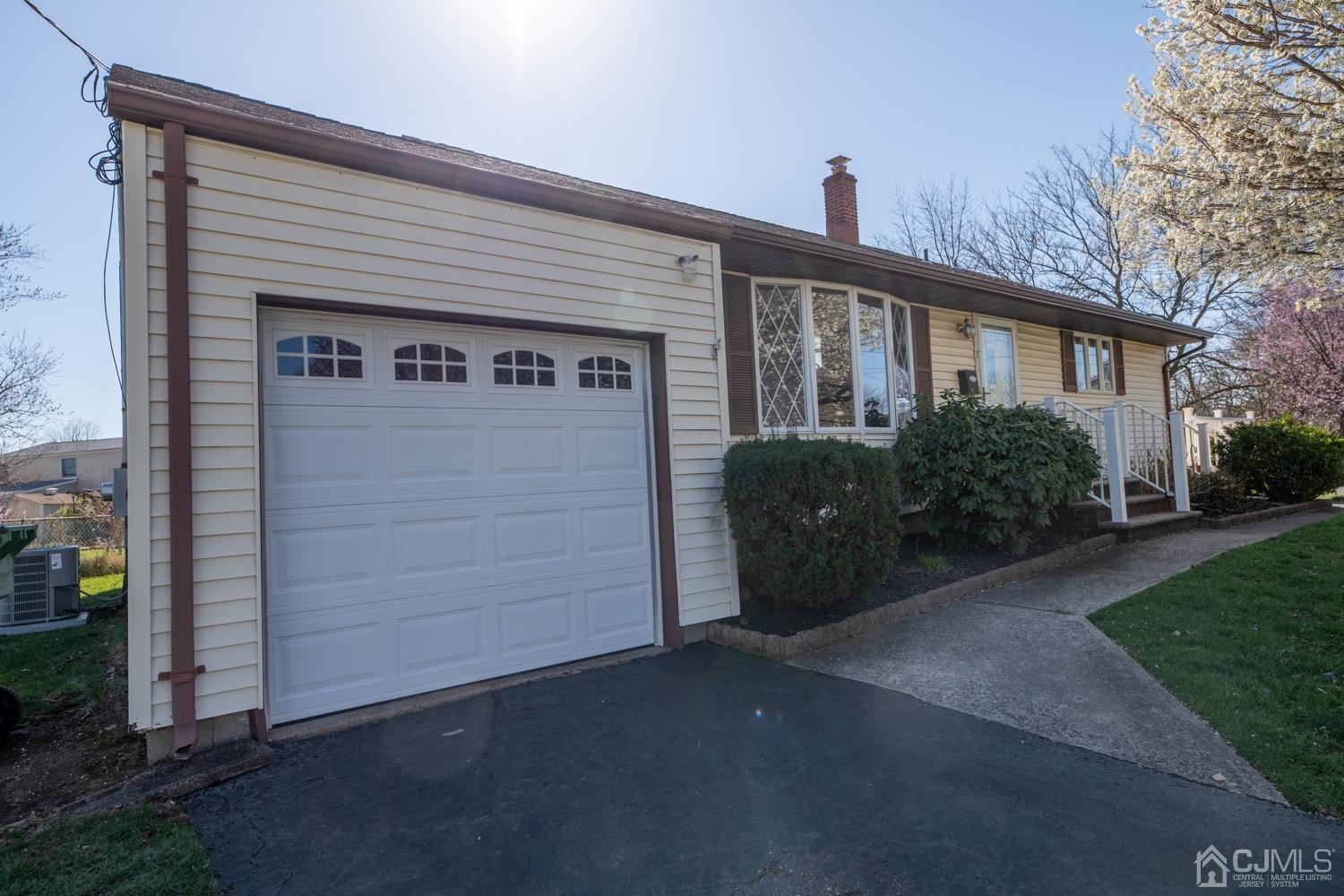 7 Sims Road Edison, NJ 08817 - Photo 3 of 54 a front view of a house with a garden