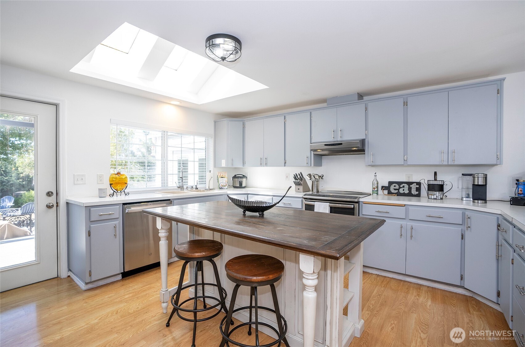 4712 Brookdale Road East Tacoma, WA 98446 - Photo 15 of 40 a kitchen with stainless steel appliances granite countertop a table chairs sink and cabinets
