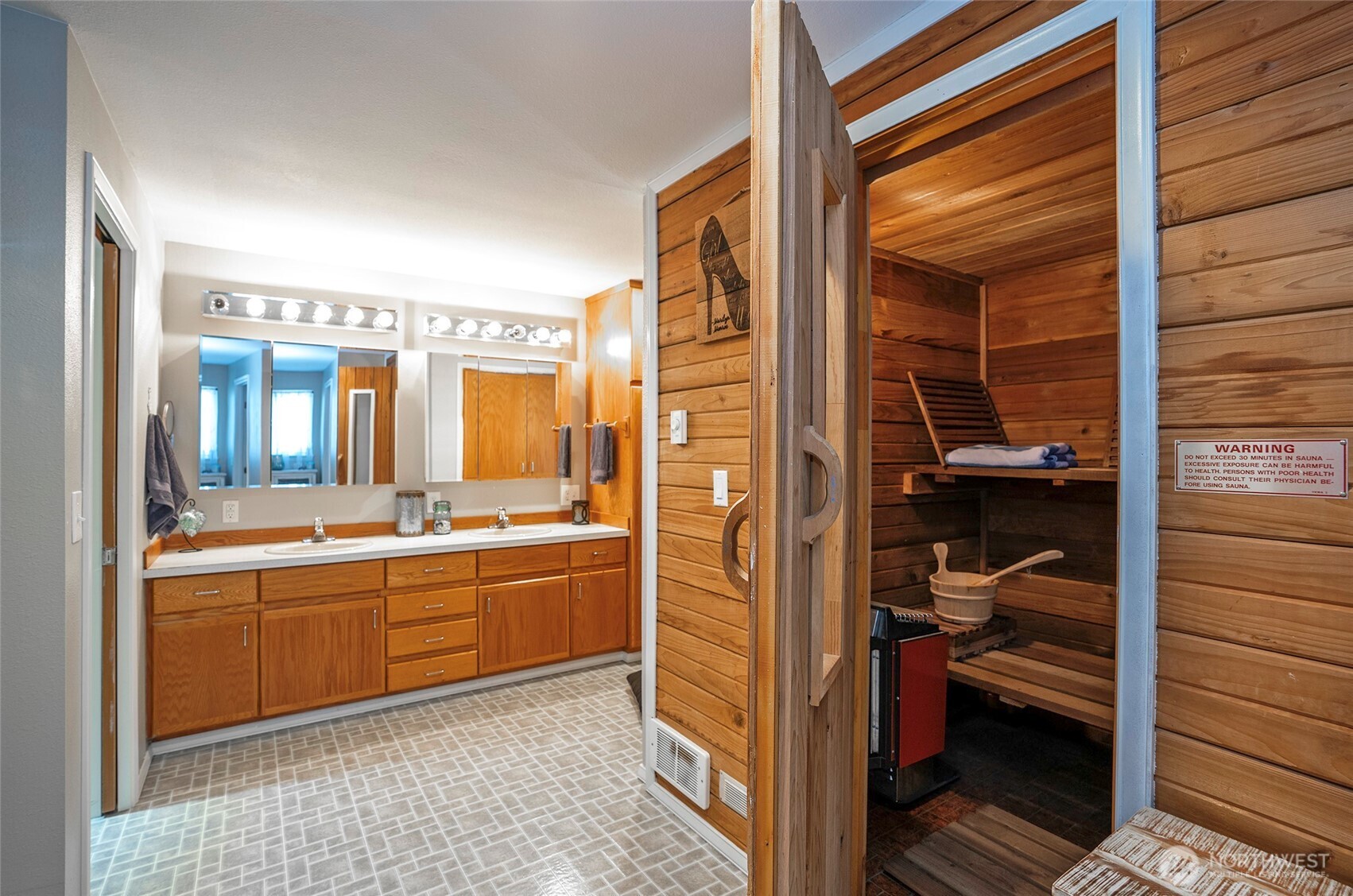 4712 Brookdale Road East Tacoma, WA 98446 - Photo 24 of 40 a en suite bathroom with a sink and a mirror