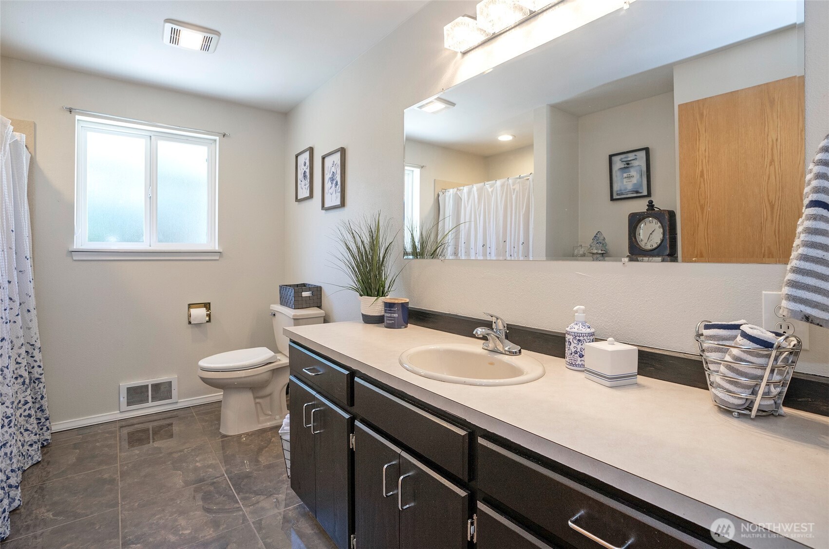 4712 Brookdale Road East Tacoma, WA 98446 - Photo 26 of 40 a bathroom with a granite countertop toilet sink and mirror