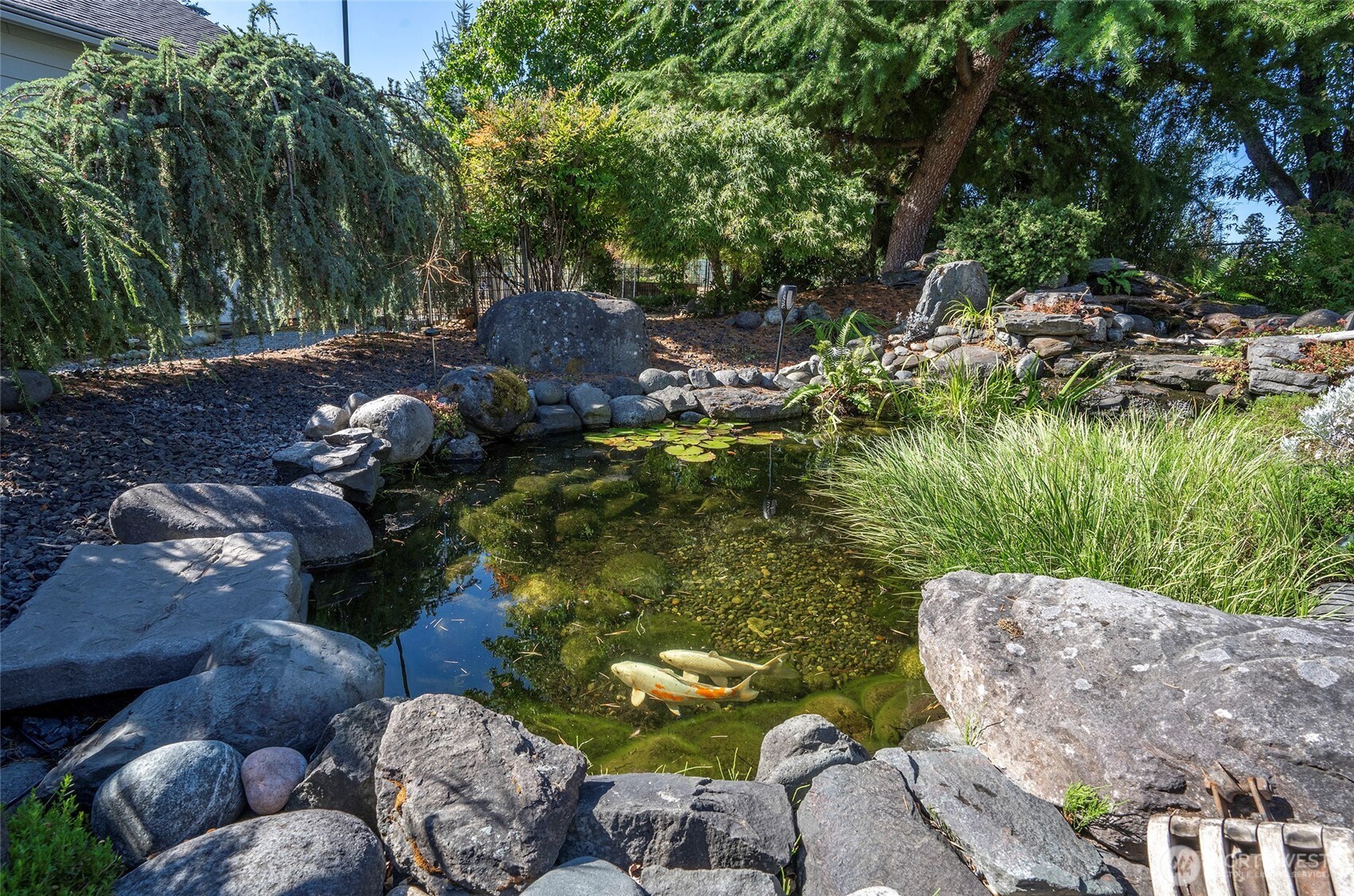 4712 Brookdale Road East Tacoma, WA 98446 - Photo 10 of 40 a view of a lake with large trees