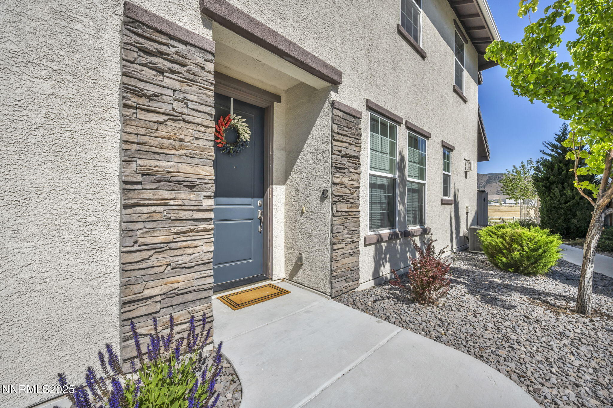 1940 Dark Horse Road, Unit C Reno, NV 89521 - Photo 16 of 69 a backyard of a house with potted plants and brick wall