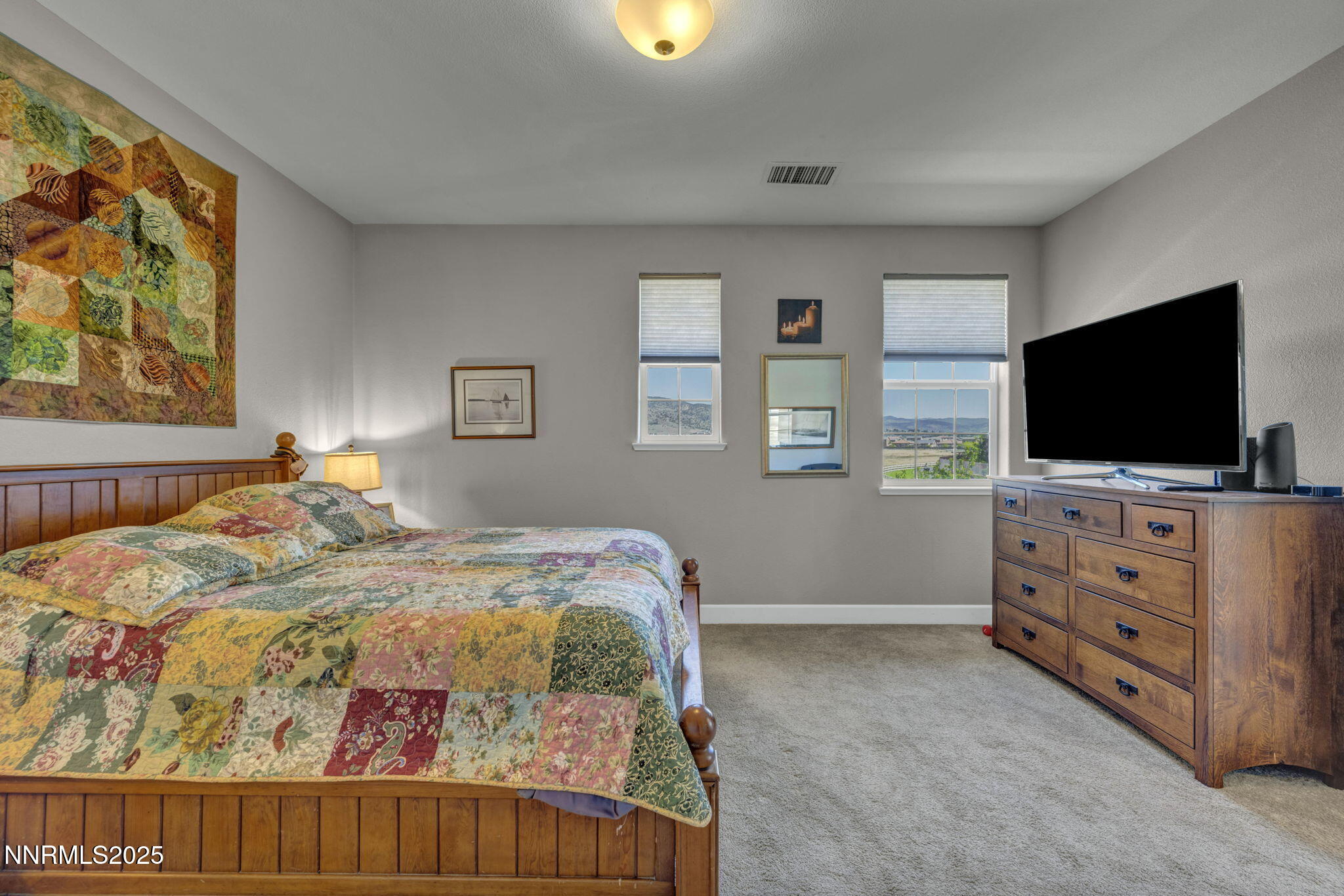 1940 Dark Horse Road, Unit C Reno, NV 89521 - Photo 47 of 69 a bedroom with a bed and a flat screen tv