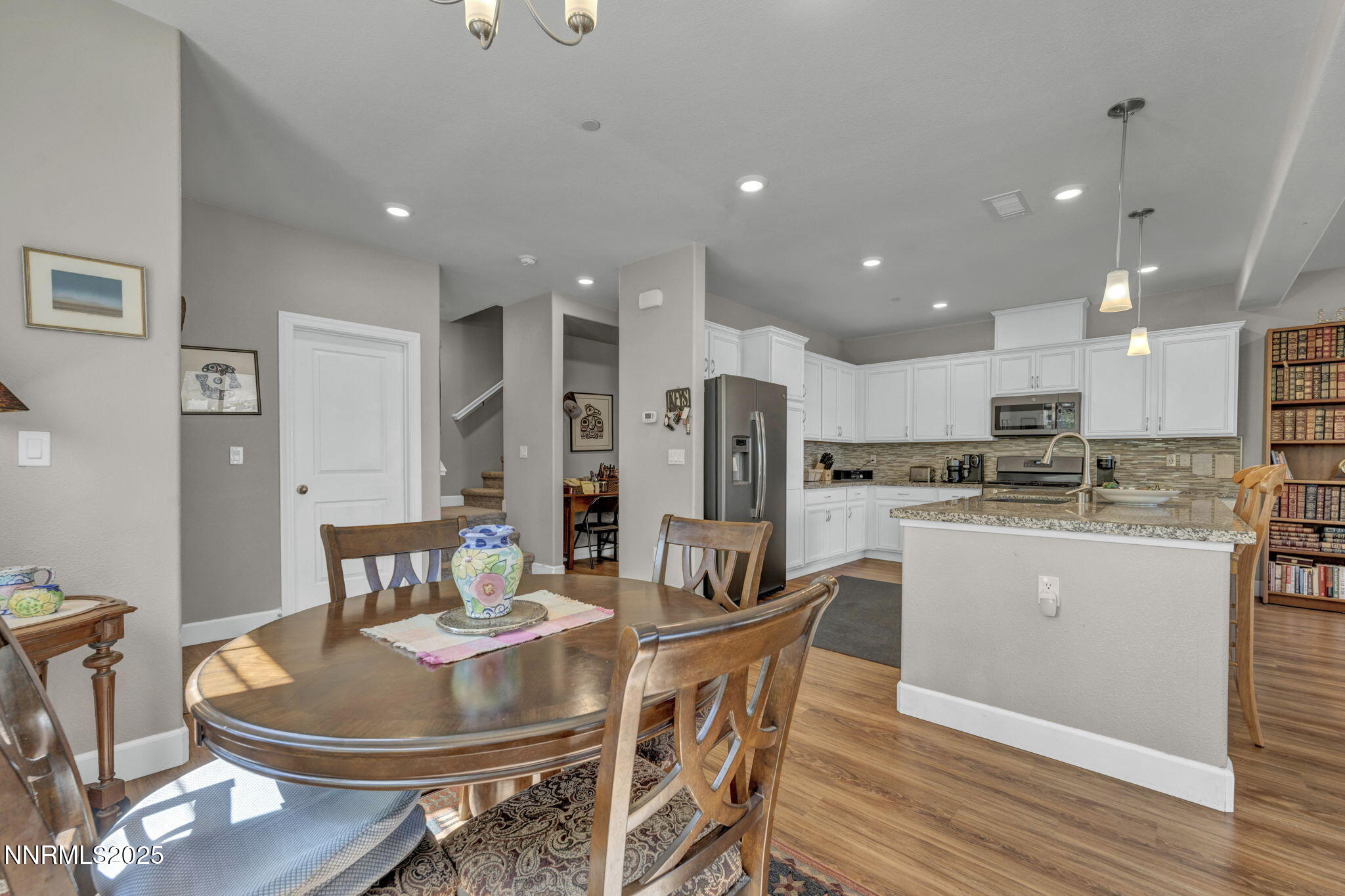 1940 Dark Horse Road, Unit C Reno, NV 89521 - Photo 58 of 69 a dining room with stainless steel appliances kitchen island granite countertop a dining table and chairs