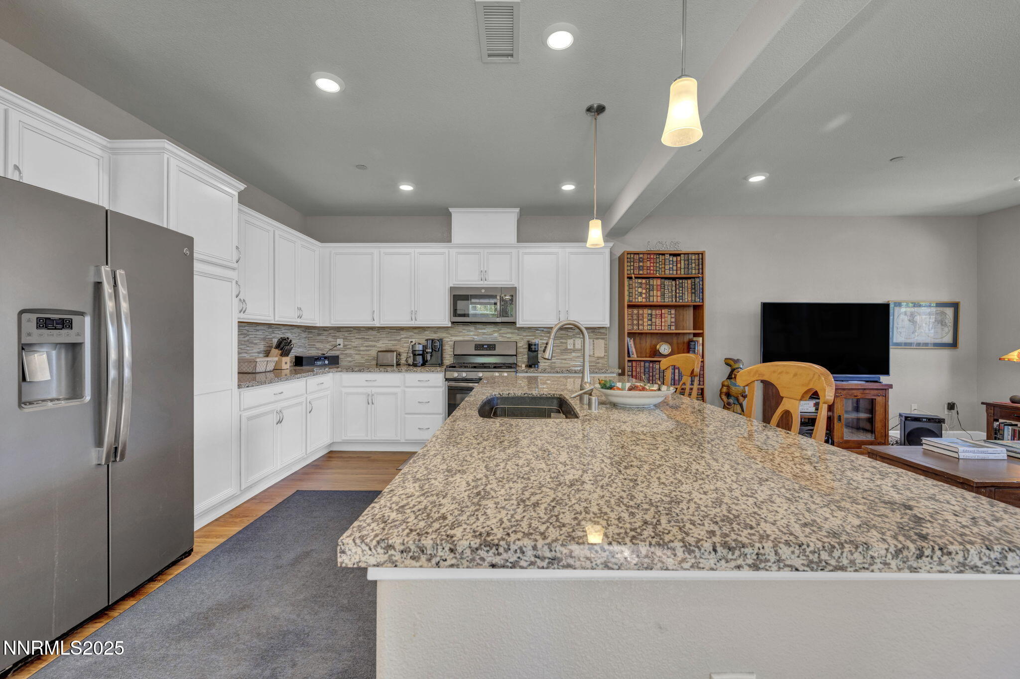 1940 Dark Horse Road, Unit C Reno, NV 89521 - Photo 62 of 69 a large kitchen with kitchen island a sink a center island stainless steel appliances and a counter top space