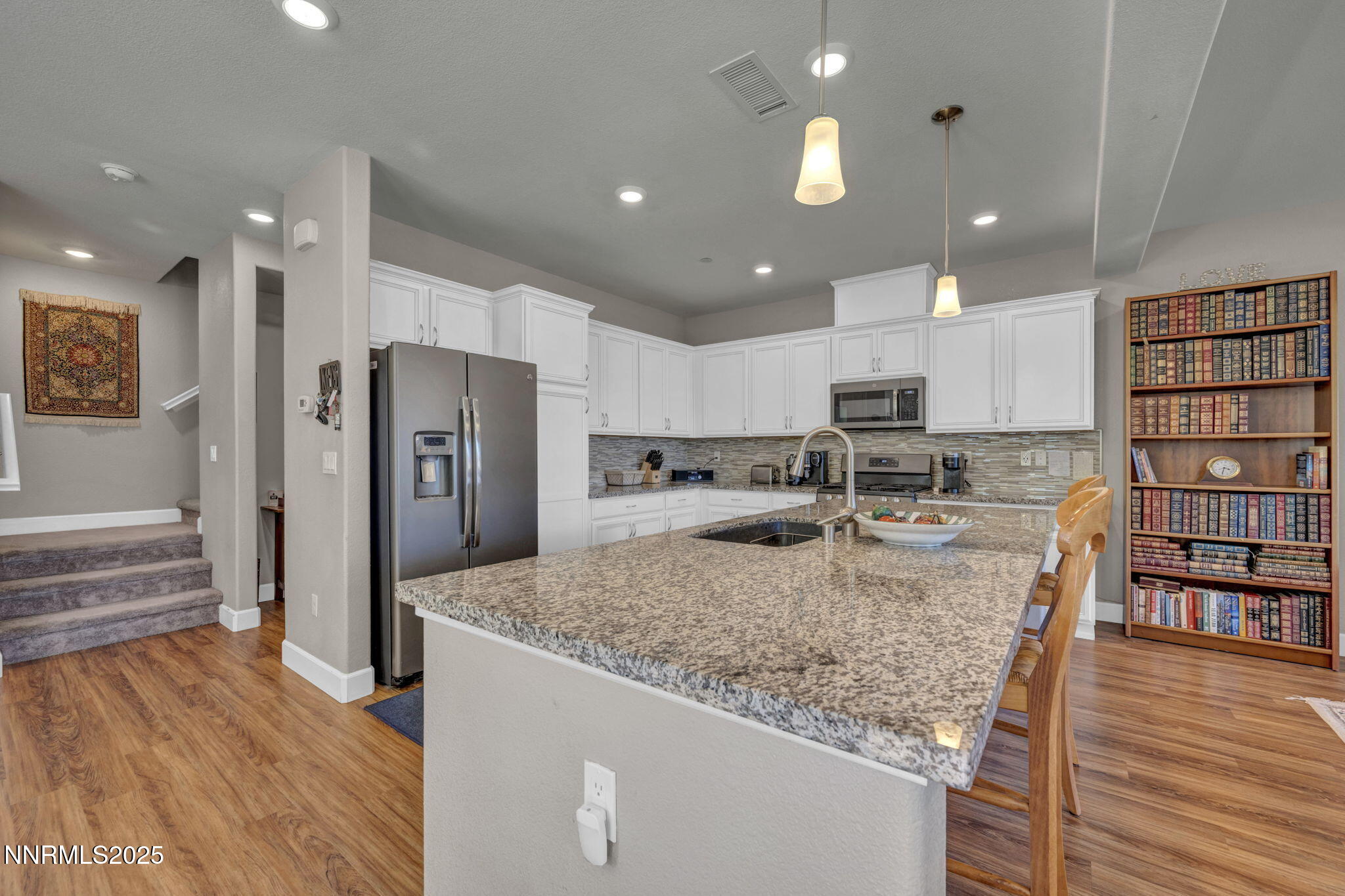1940 Dark Horse Road, Unit C Reno, NV 89521 - Photo 63 of 69 a kitchen with stainless steel appliances granite countertop a refrigerator and a stove top oven