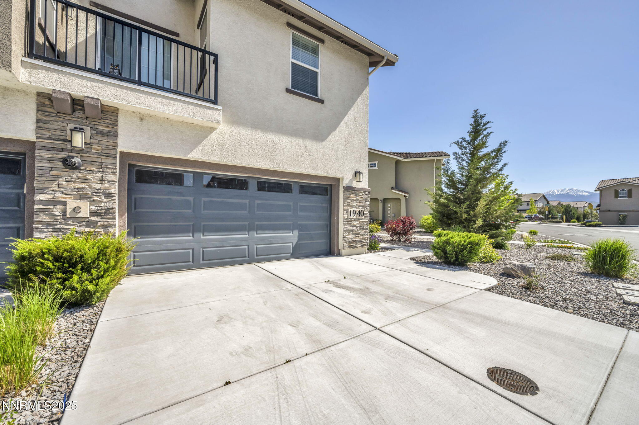 1940 Dark Horse Road, Unit C Reno, NV 89521 - Photo 67 of 69 a front view of a house with a yard and garage