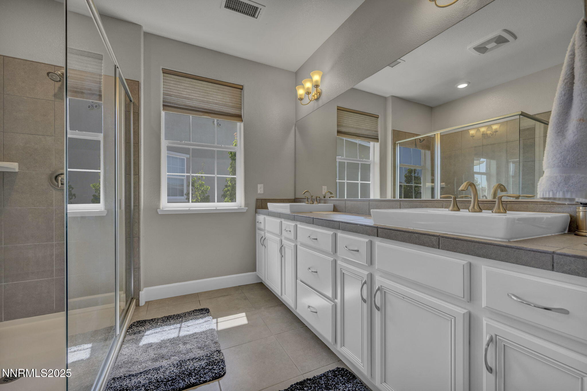 1940 Dark Horse Road, Unit C Reno, NV 89521 - Photo 7 of 69 a bathroom with a double vanity sink and a mirror