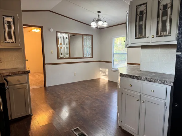 a view of a kitchen with dishwasher and wooden floor