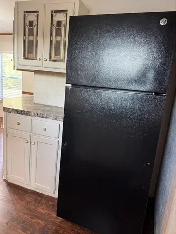 a view of storage and utility room with wooden floor