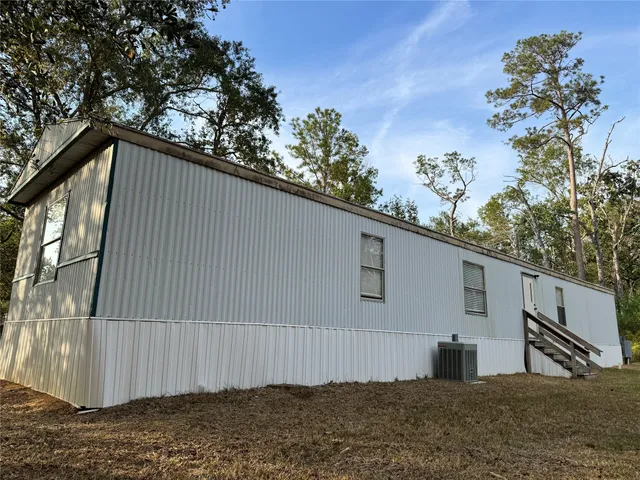 a view of a house with a backyard