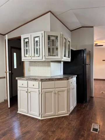 a kitchen with stainless steel appliances granite countertop a refrigerator stove and wooden floor