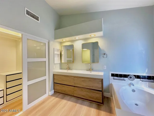 a bathroom with a bathtub and a sink