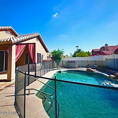 a view of house with backyard and slide