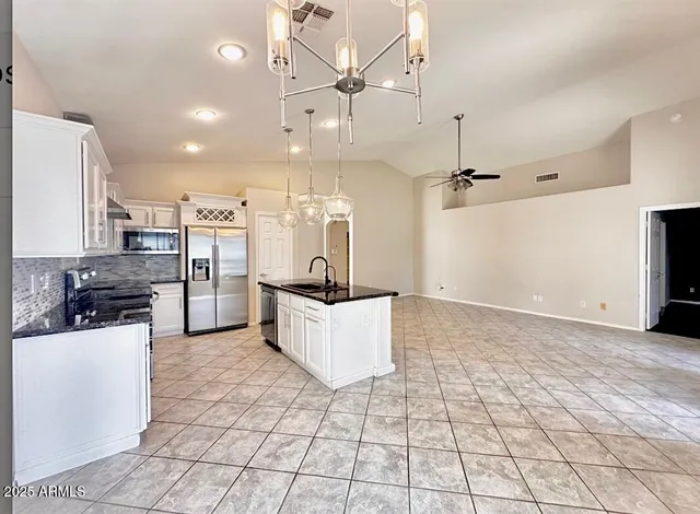 a large kitchen with cabinets and stainless steel appliances