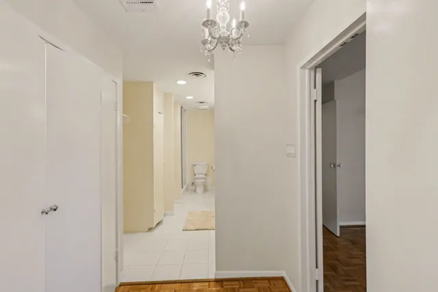 a spacious bathroom with a granite countertop toilet a sink and a mirror