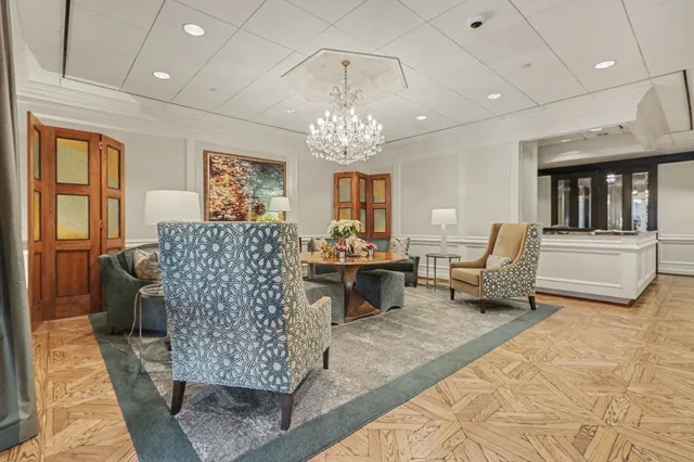 a living room with furniture and flowers