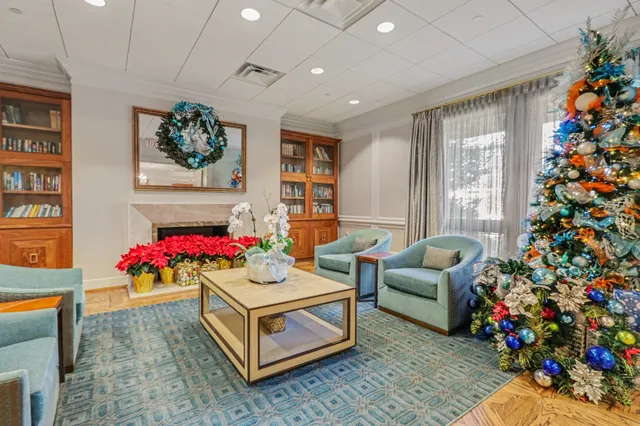 a living room with furniture and a dining table