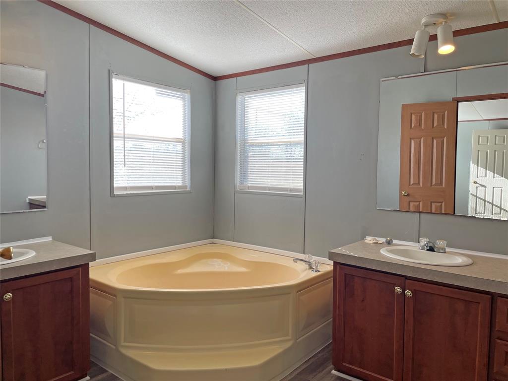 9624 Clark Street Joshua, TX 76058 - Photo 12 of 22 a bathroom with a tub sink and mirror