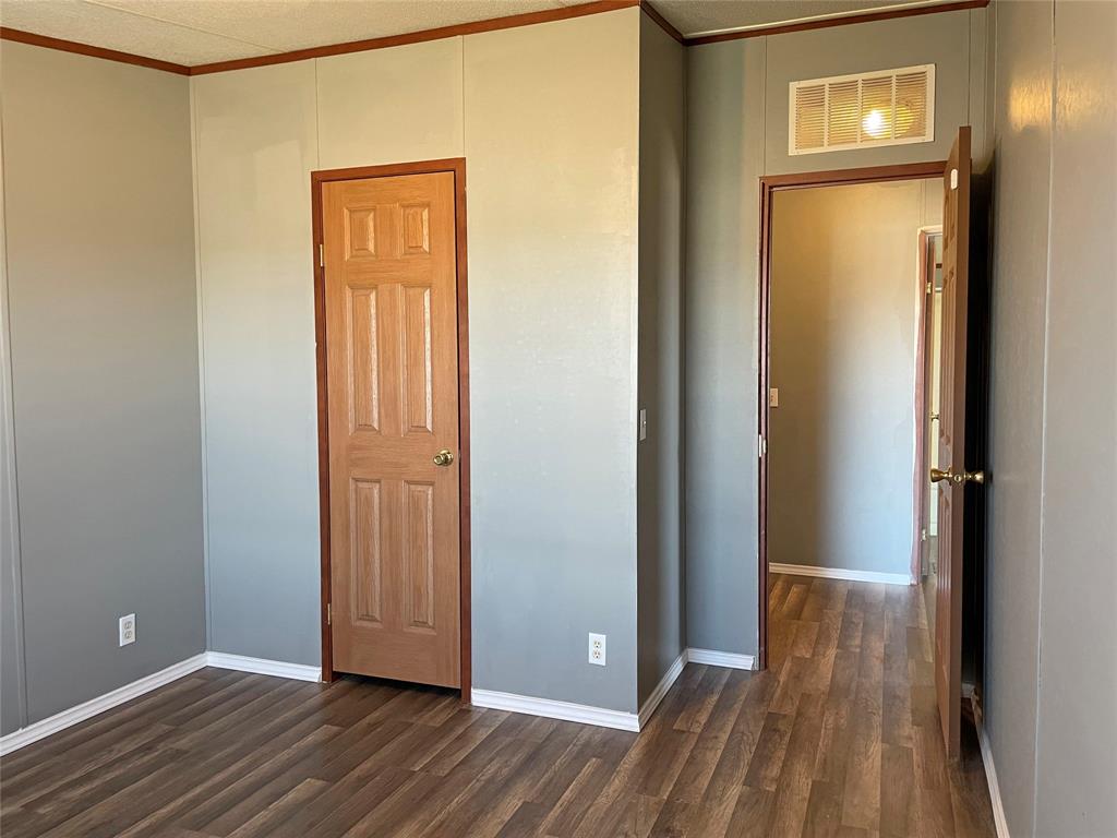 9624 Clark Street Joshua, TX 76058 - Photo 16 of 22 a view of a hallway with wooden floor