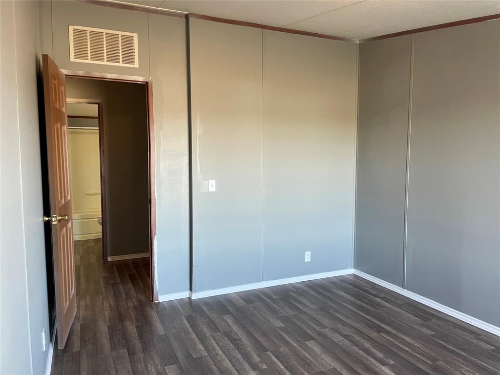 9624 Clark Street Joshua, TX 76058 - Photo 18 of 22 a view of a hallway with wooden floor