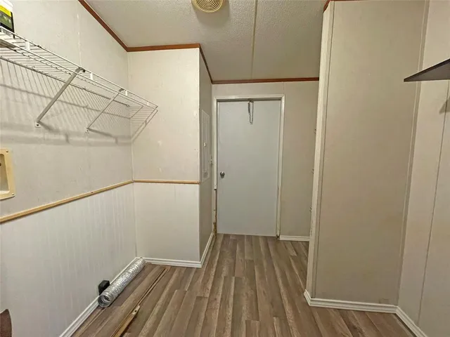 a view of a room with wooden floor