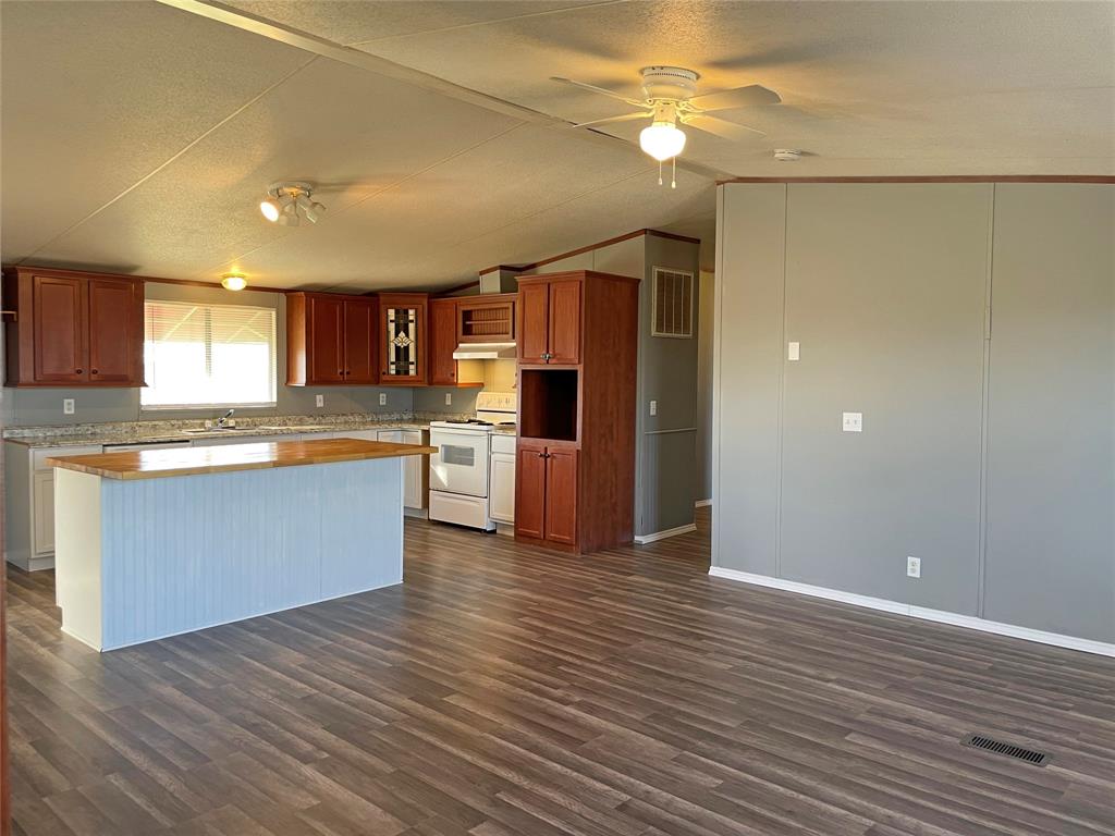 9624 Clark Street Joshua, TX 76058 - Photo 4 of 22 a kitchen with stainless steel appliances granite countertop a refrigerator and a stove top oven