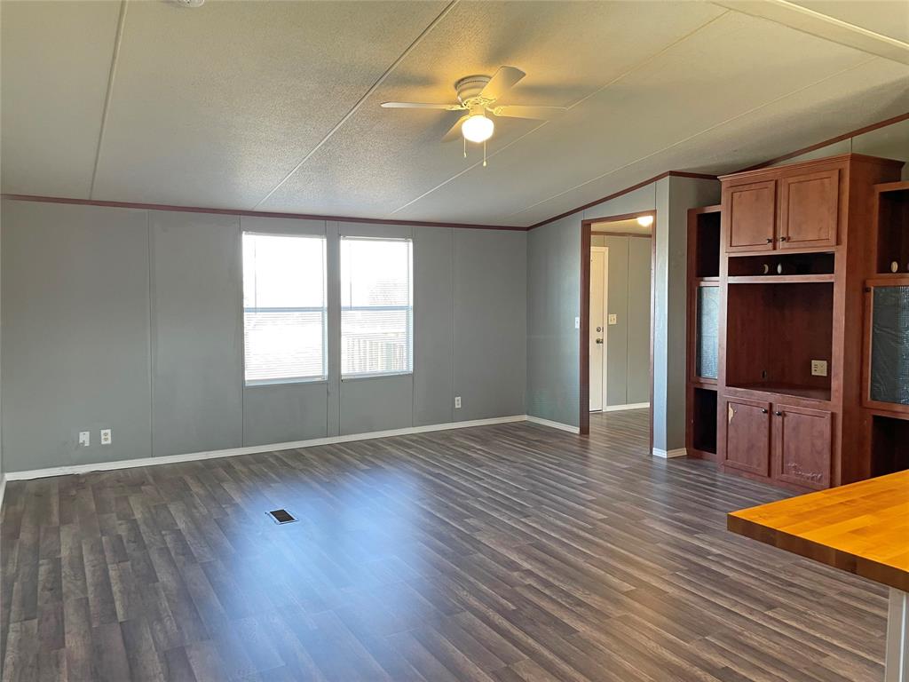 9624 Clark Street Joshua, TX 76058 - Photo 7 of 22 an empty room with wooden floor and windows