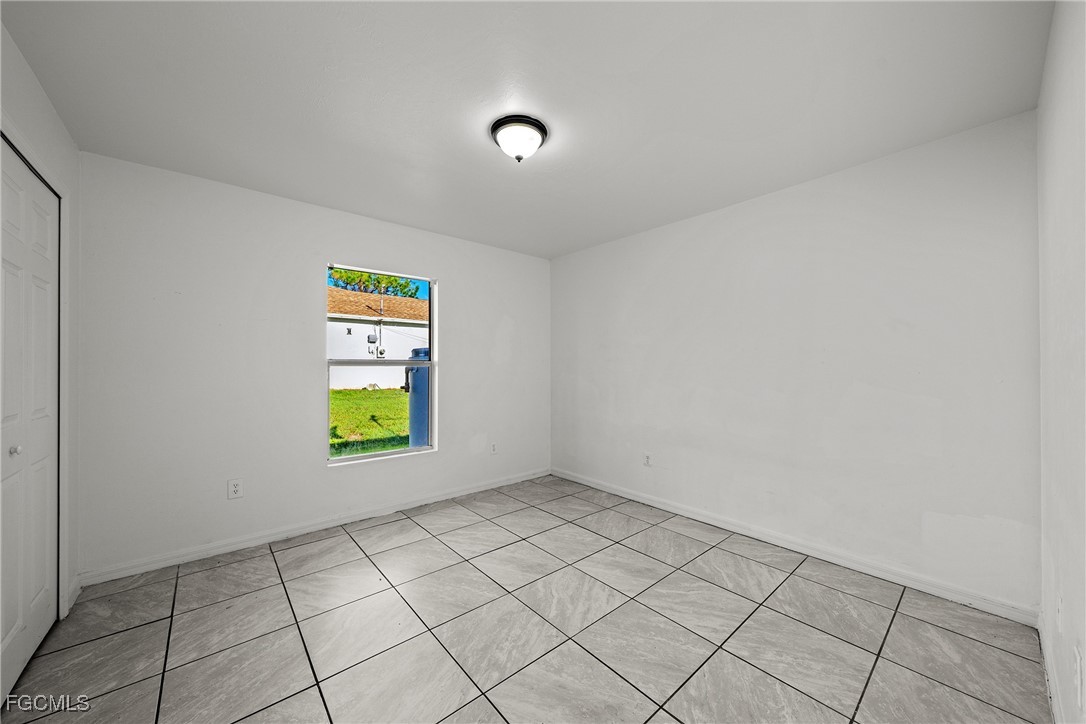 4735 30th Street Southwest Lehigh Acres, FL 33973 - Photo 12 of 43 a view of an empty room and window