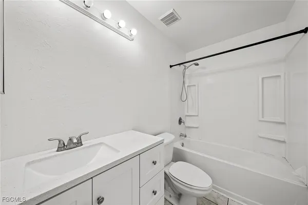a bathroom with a sink toilet vanity and shower