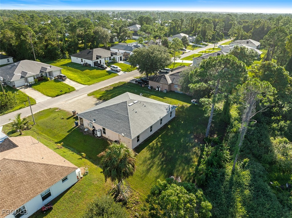 4735 30th Street Southwest Lehigh Acres, FL 33973 - Photo 33 of 43 an aerial view of residential houses with outdoor space