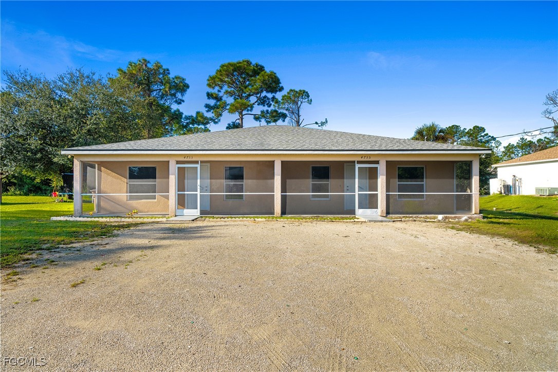 4735 30th Street Southwest Lehigh Acres, FL 33973 - Photo 34 of 43 front view of a house with a yard