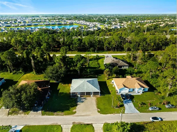 an aerial view of residential houses with outdoor space and swimming pool