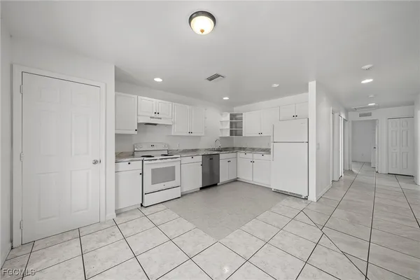 a kitchen with a white cabinets and white appliances