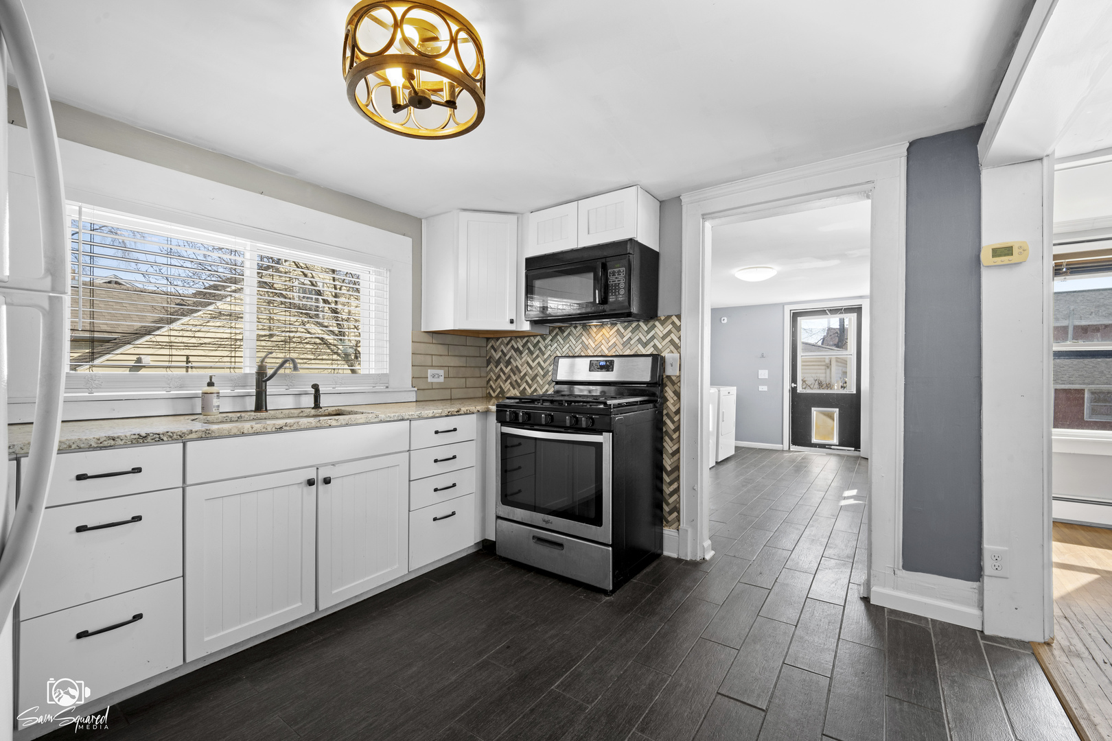 10947 1st Street Mokena, IL 60448 - Photo 9 of 29 a kitchen with stainless steel appliances granite countertop a stove and a sink
