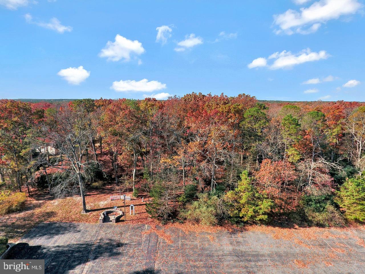 40 Schoolhouse Road Manchester Township, NJ 08759 - Photo 5 of 5 a view of a terrace with a bench and chairs
