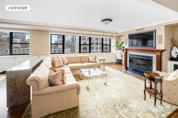 a living room with furniture large window and a fireplace