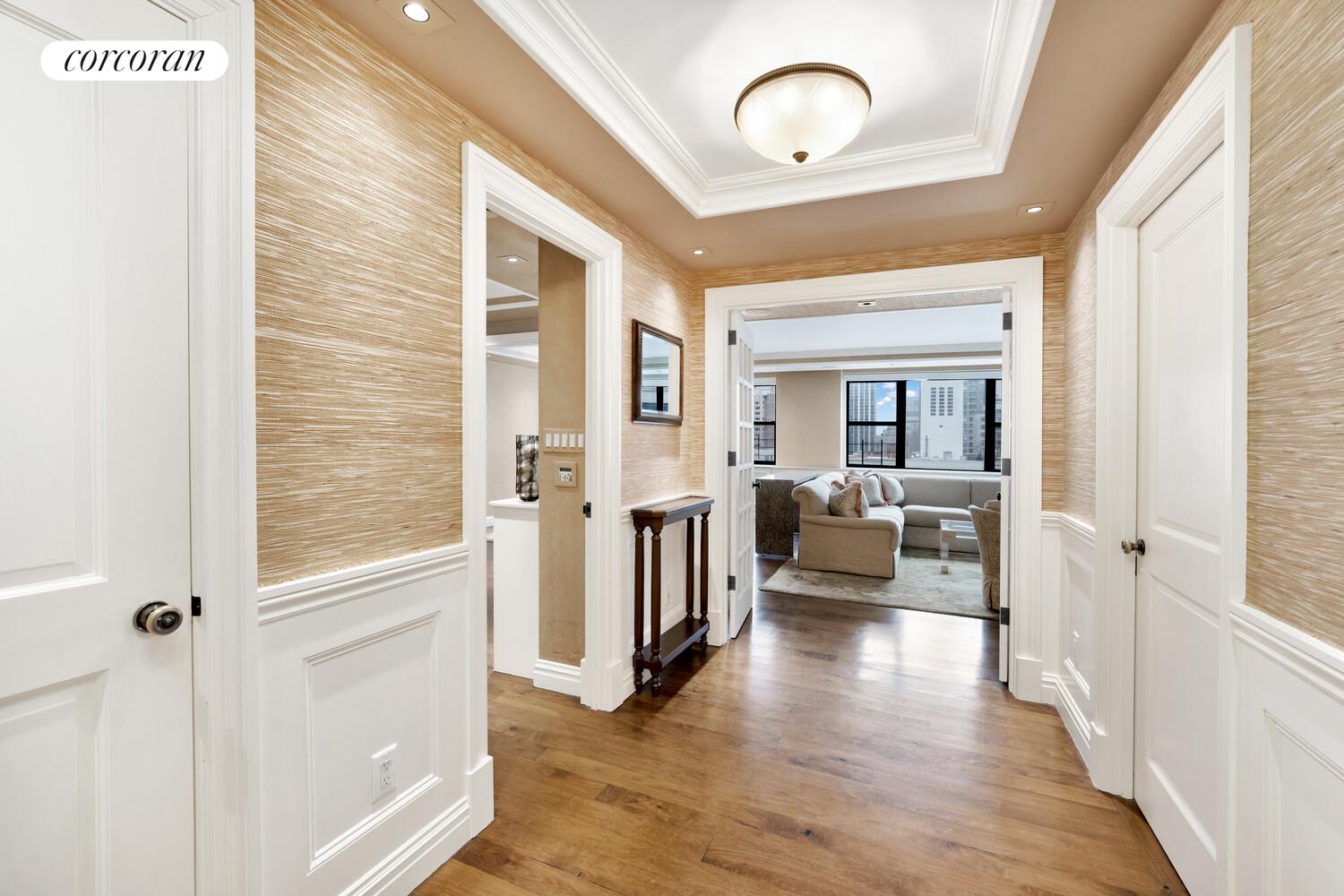 233 East 69th Street, Unit 14K Manhattan, NY 10021 - Photo 4 of 12 a view of a livingroom with furniture and a ceiling fan