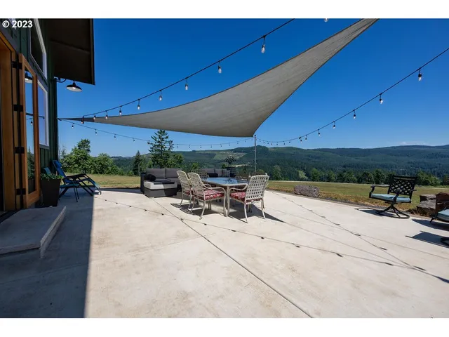 a view of a patio with table and chairs under an umbrella