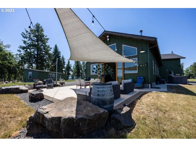a view of a house with swimming pool and sitting area