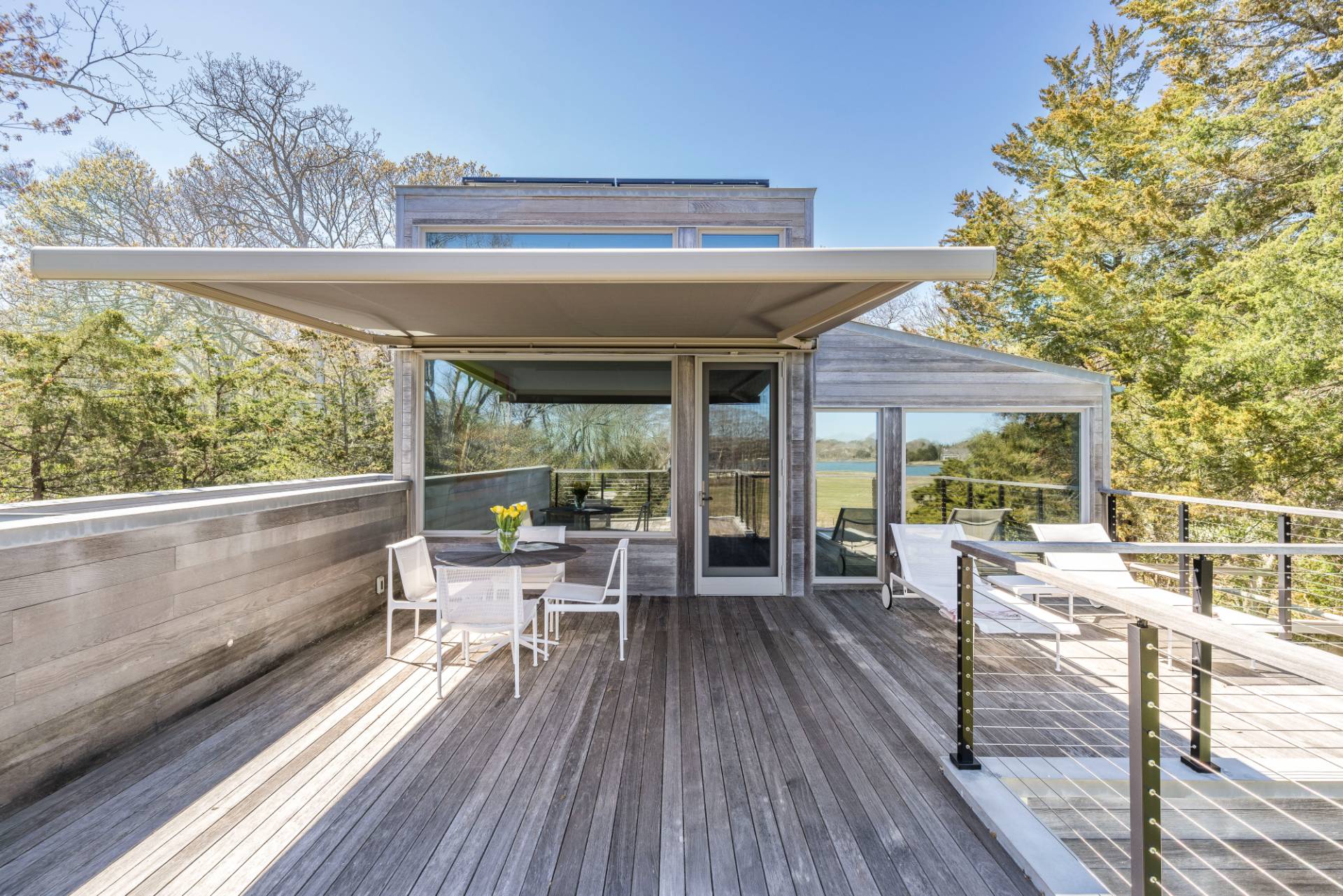 1084 Springs Fireplace Road East Hampton, NY 11937 - Photo 17 of 33 a view of balcony with chairs and wooden floor