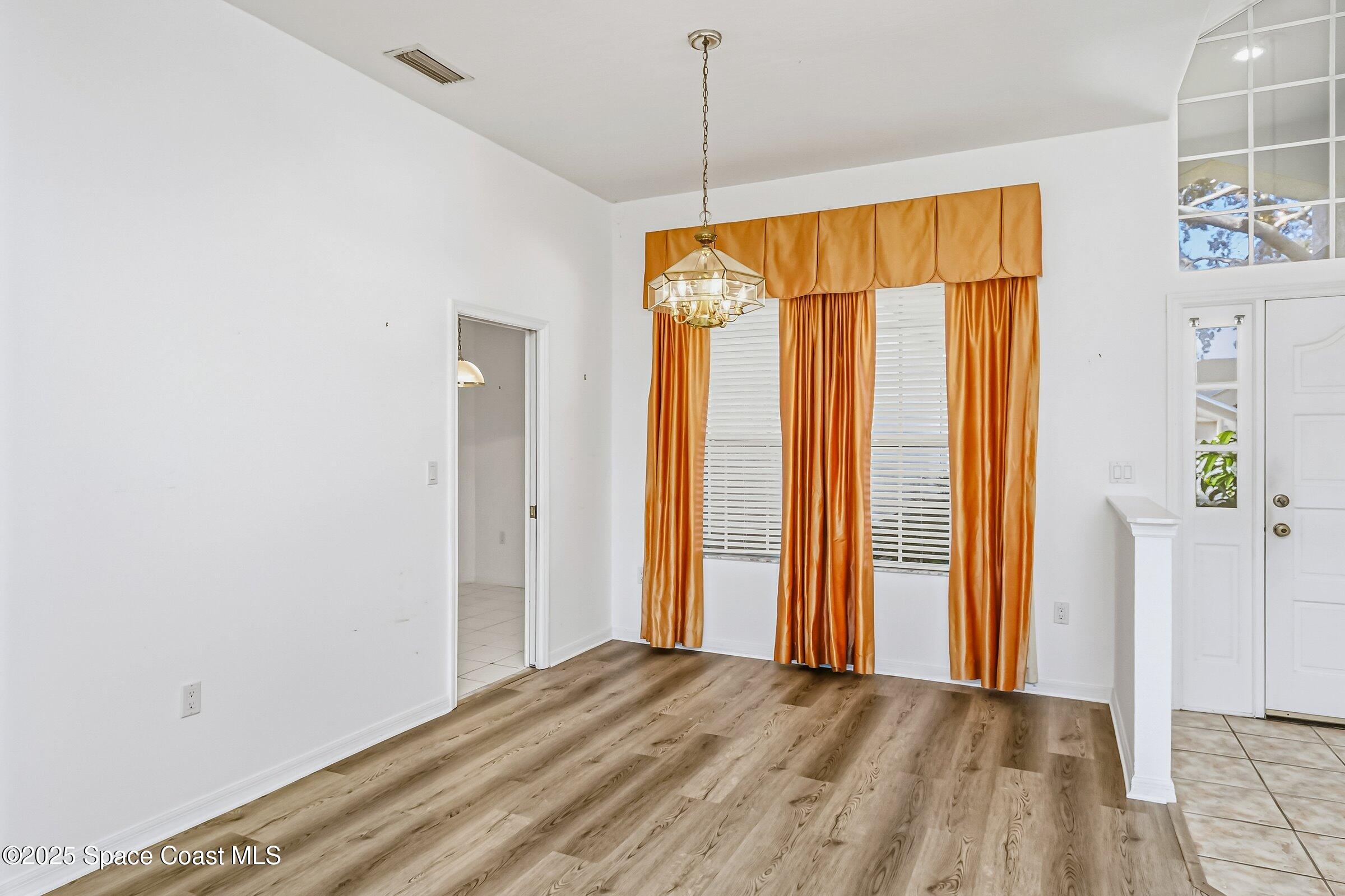 4048 Sand Ridge Drive Merritt Island, FL 32953 - Photo 11 of 70 a view of a room with wooden floor and a window