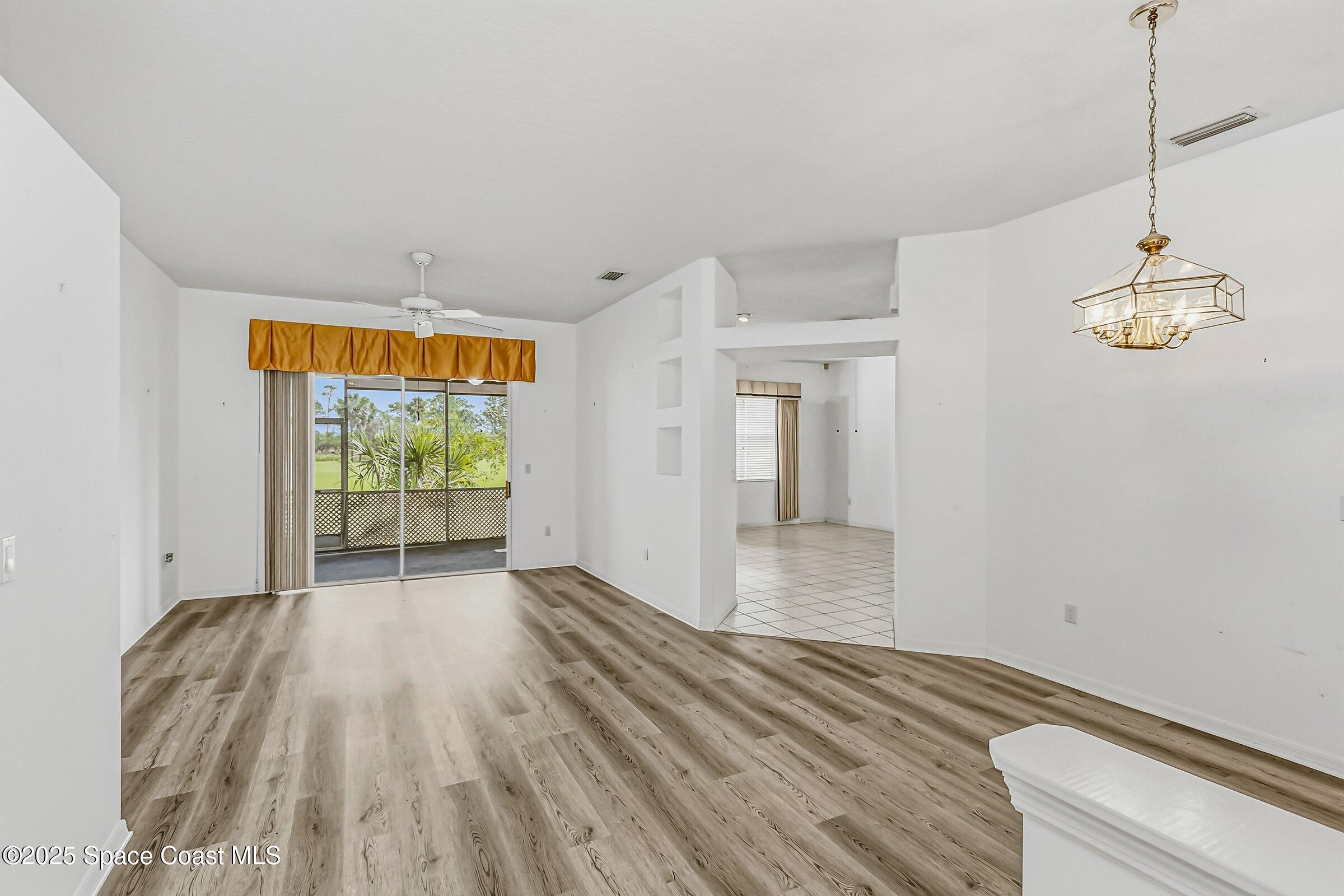 4048 Sand Ridge Drive Merritt Island, FL 32953 - Photo 12 of 70 a view of empty room with wooden floor and fan