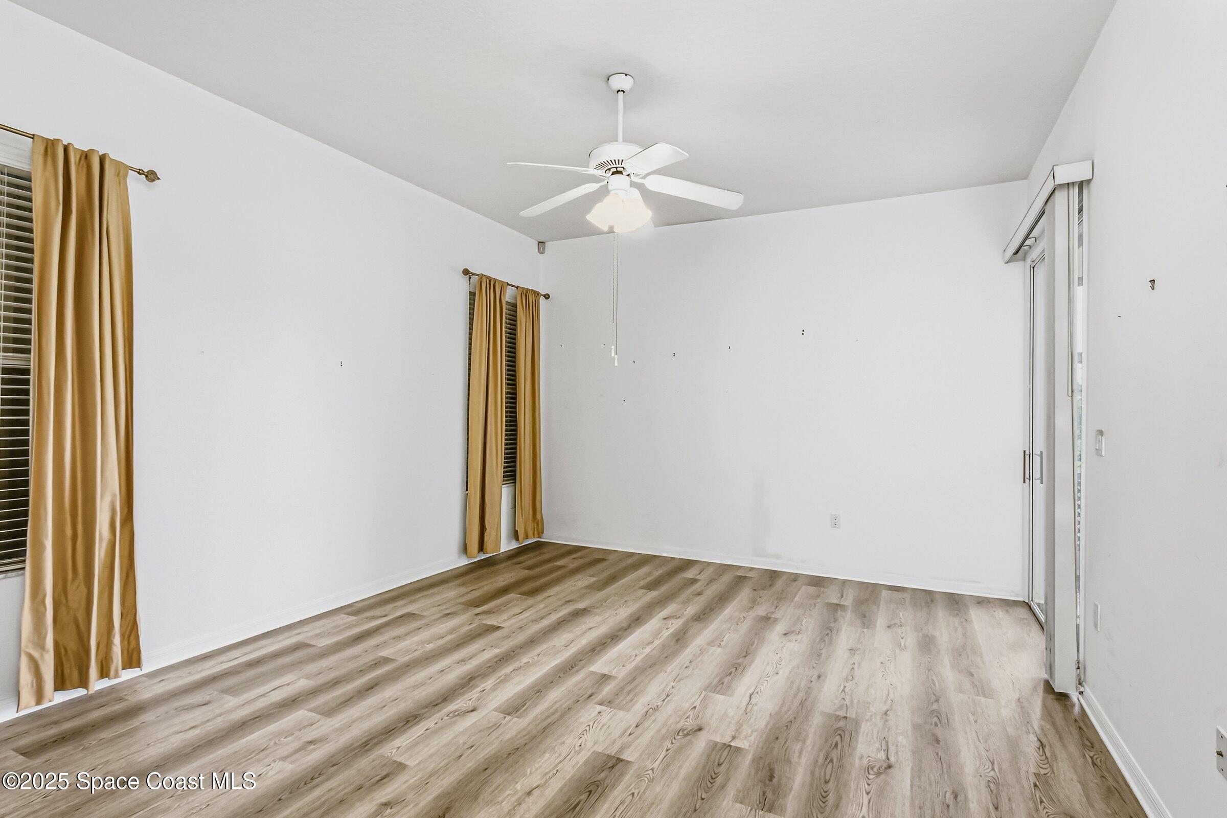 4048 Sand Ridge Drive Merritt Island, FL 32953 - Photo 21 of 70 wooden floor in an empty room with a window