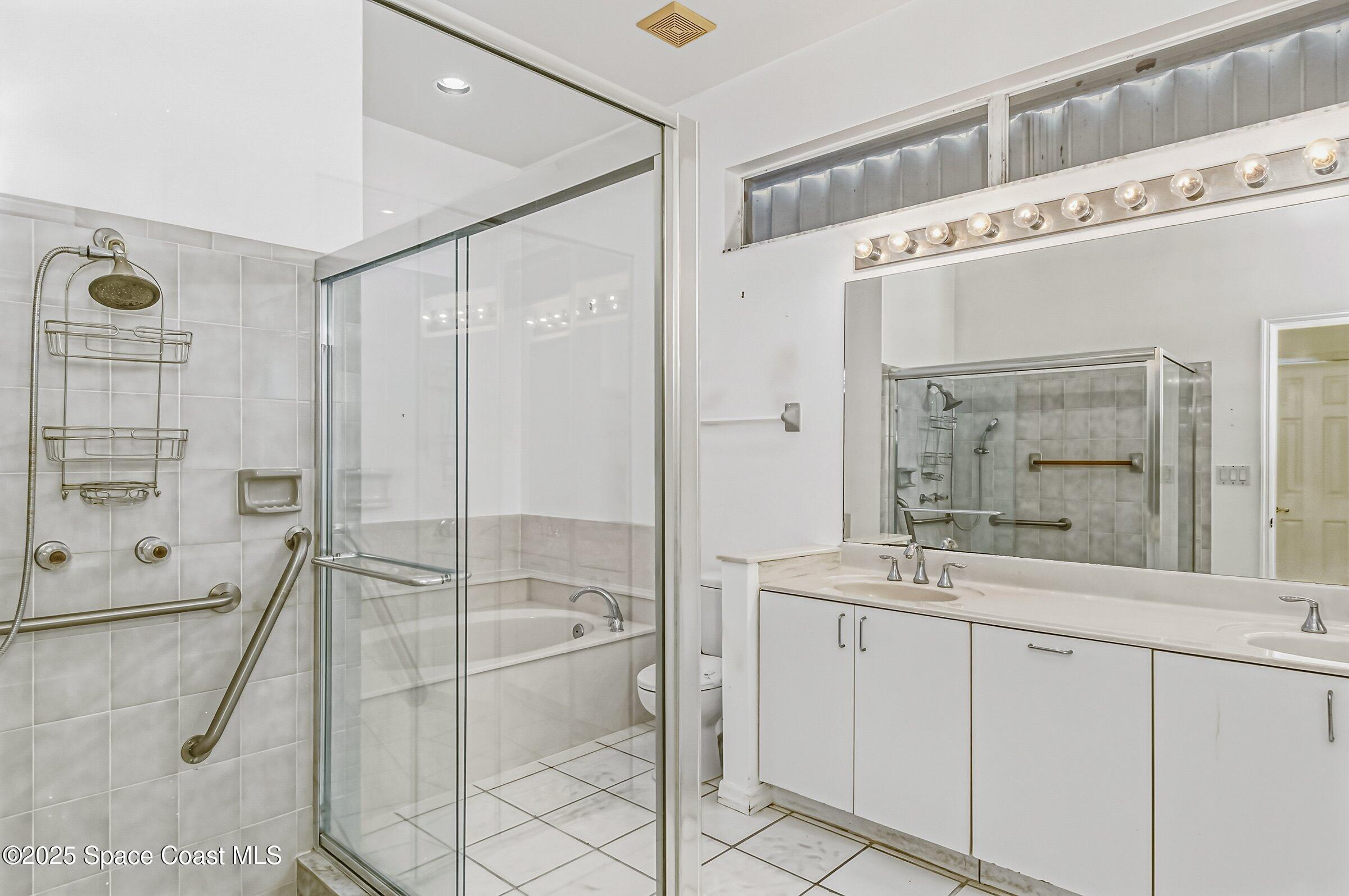 4048 Sand Ridge Drive Merritt Island, FL 32953 - Photo 23 of 70 a spacious bathroom with a granite countertop sink mirror and shower
