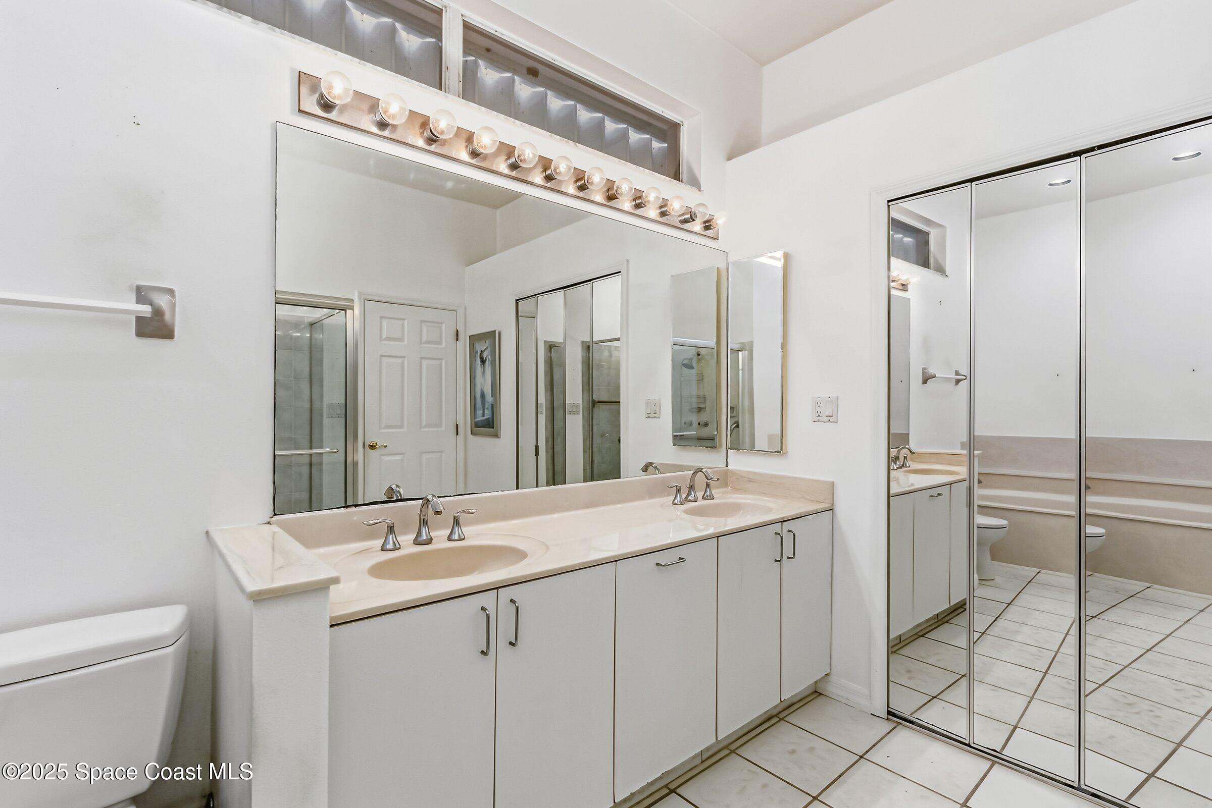 4048 Sand Ridge Drive Merritt Island, FL 32953 - Photo 26 of 70 a spacious bathroom with a granite countertop sink mirror and toilet