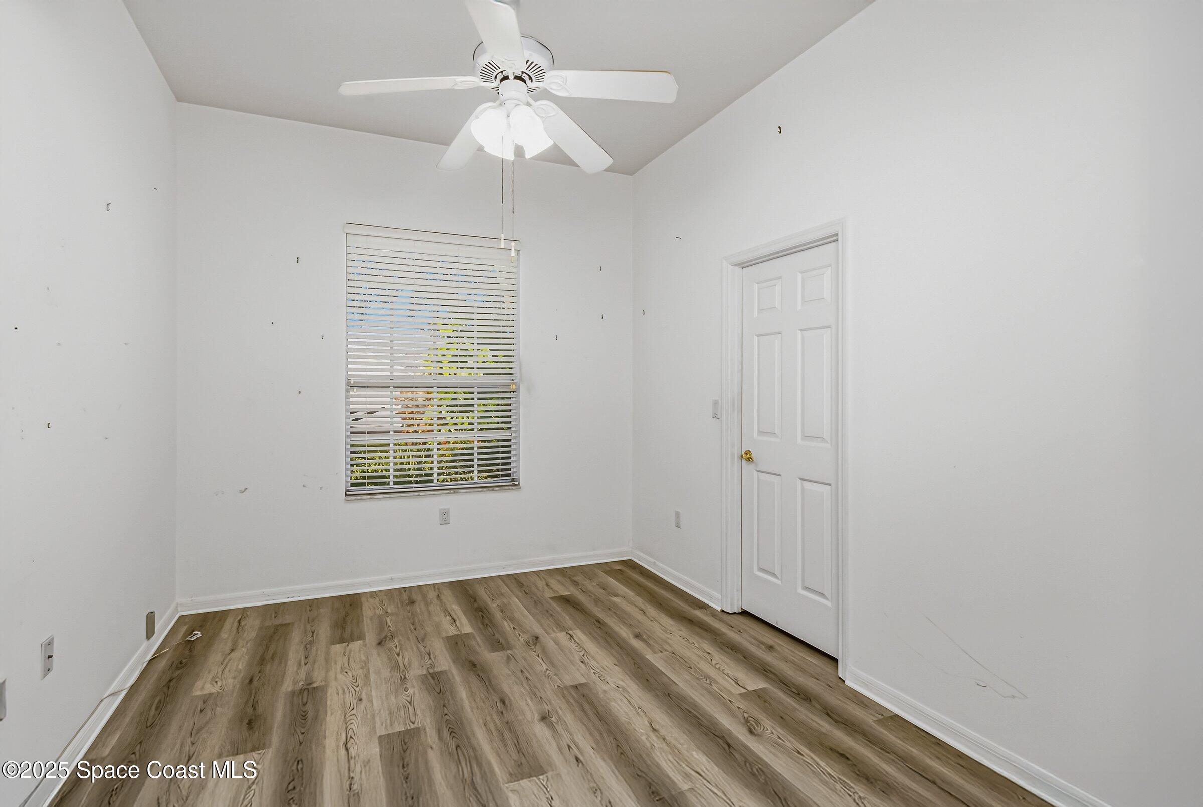 4048 Sand Ridge Drive Merritt Island, FL 32953 - Photo 31 of 70 wooden floor in an empty room with a window