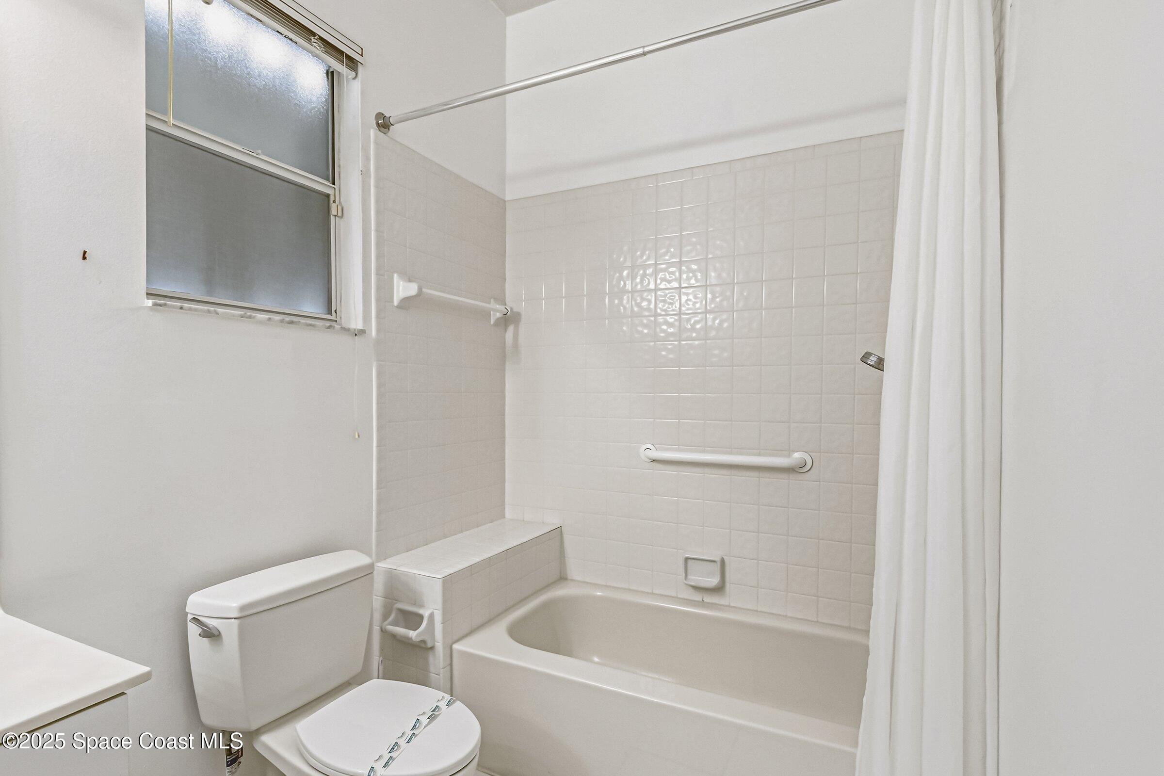 4048 Sand Ridge Drive Merritt Island, FL 32953 - Photo 36 of 70 a bathroom with a toilet and a bathtub