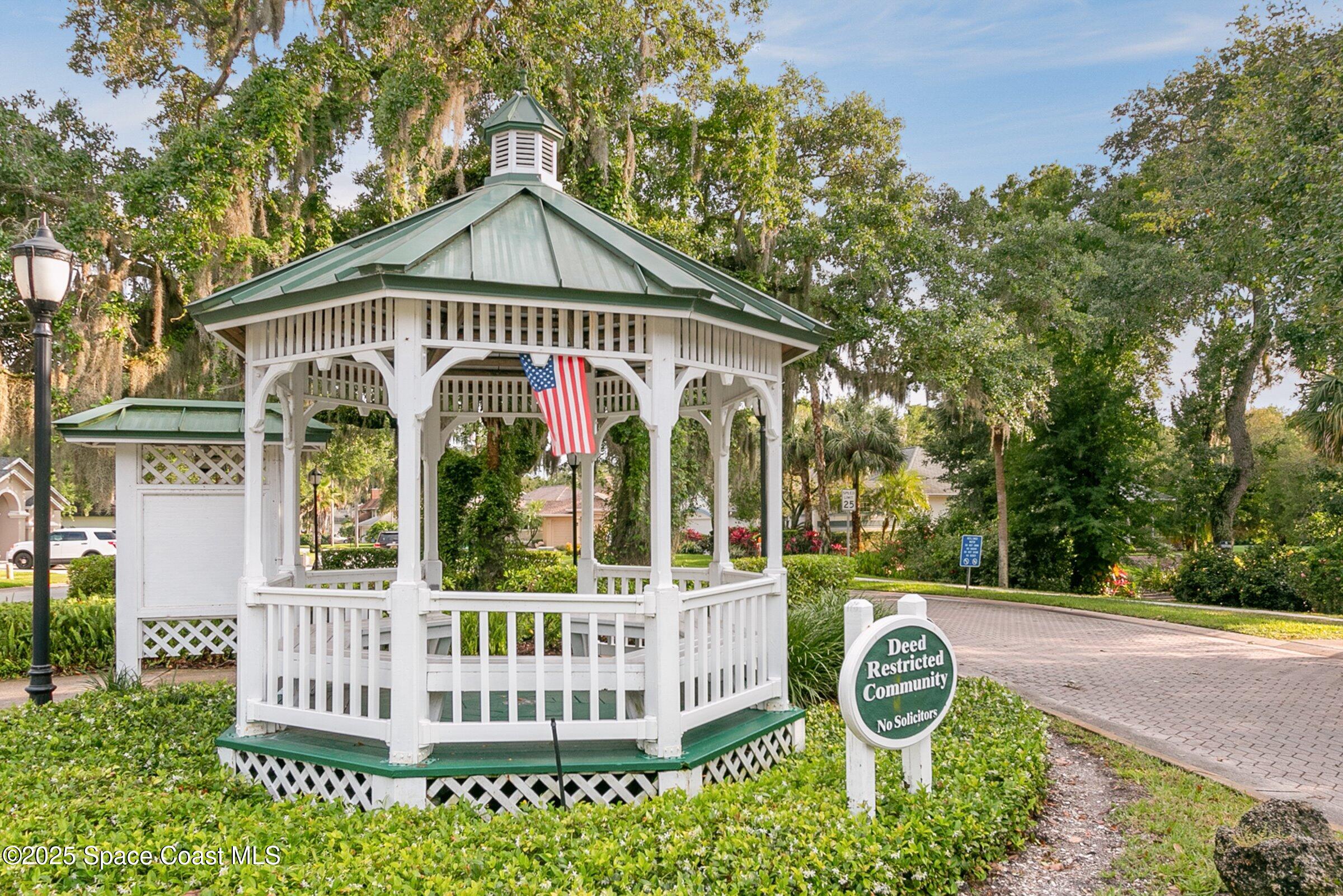 4048 Sand Ridge Drive Merritt Island, FL 32953 - Photo 54 of 70 a front view of a house with garden and porch